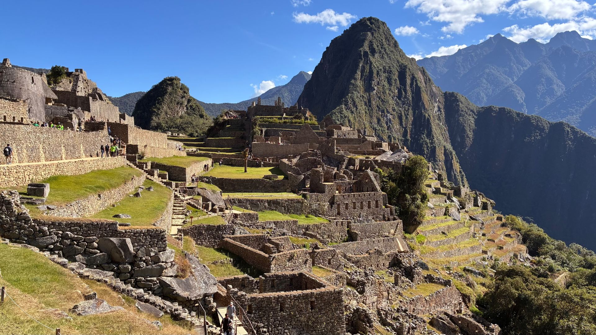 Licensed guide hiking a high-altitude trail in the Peruvian Andes at sunrise